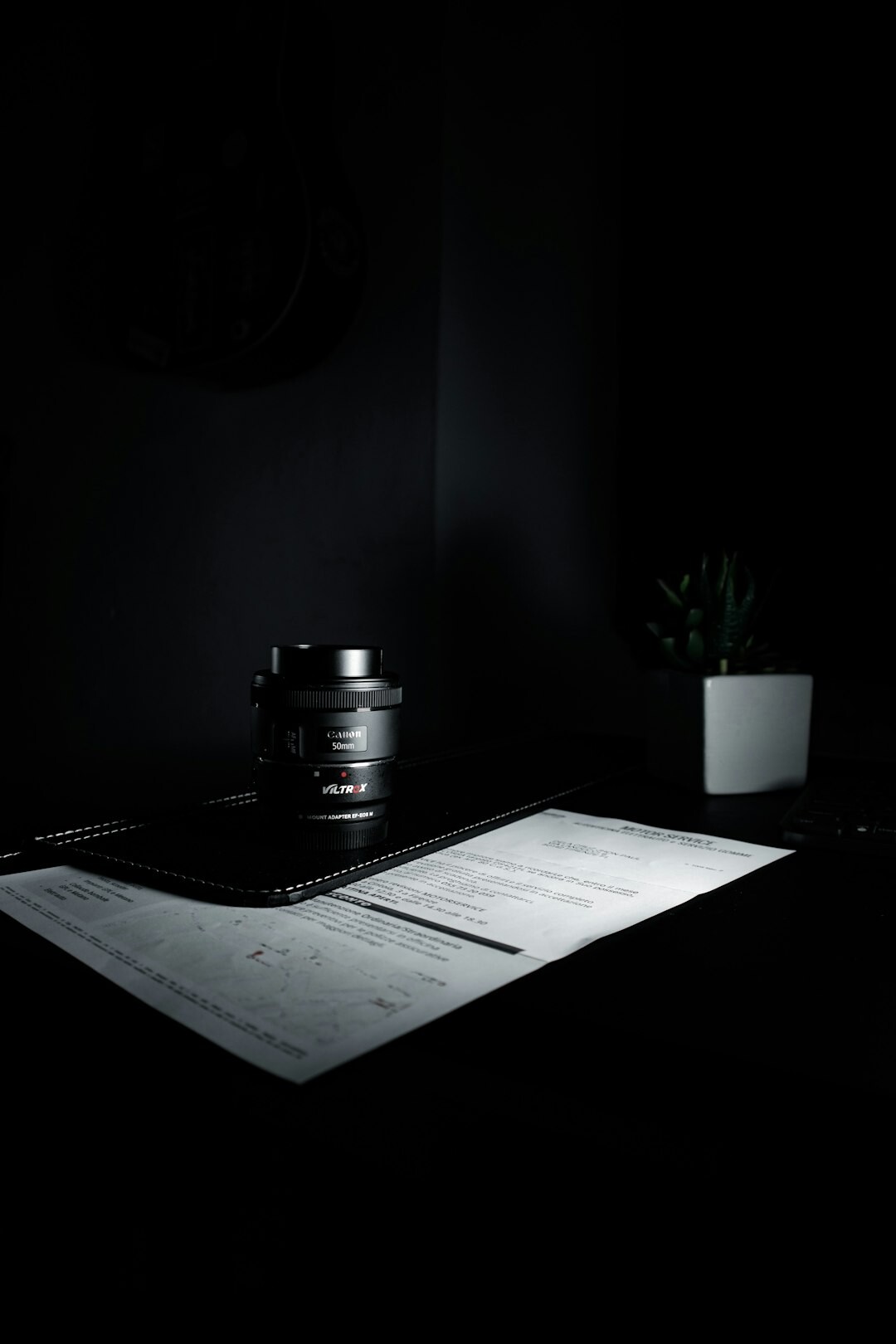 Photographer editing documentary photo contact sheets at a desk